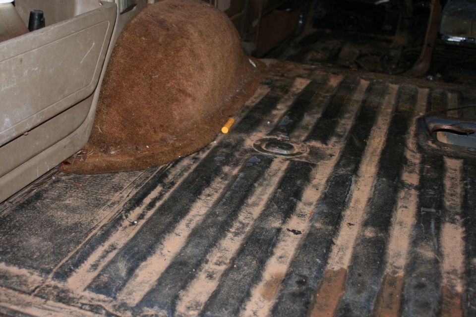 Interior cargo area with ribbed floor and brown carpeted wheel well