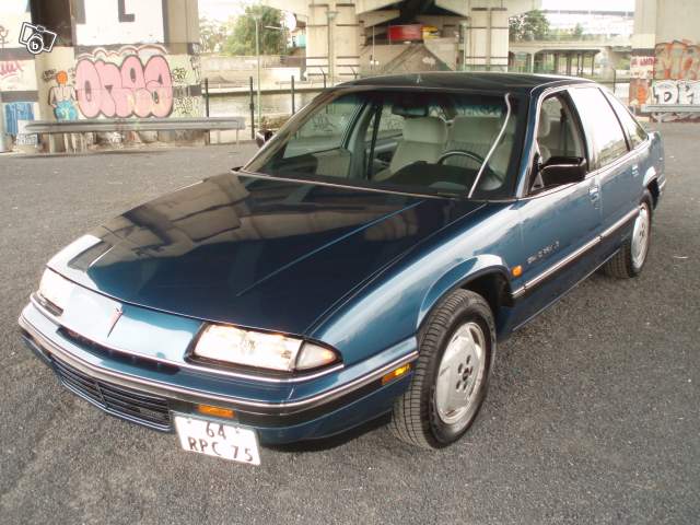 Blue sedan with a chrome grille and a license plate reading '64 RPC 75'