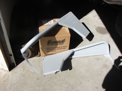 1978 Ford Bronco - Two unpainted metal fender flare parts are displayed in front of a Summit Racing Equipment box.
