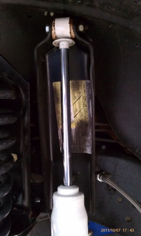 1994 Ford Bronco - Close-up of a vehicle's shock absorber, showing a sticker with technical data.