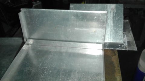 1989 Ford Bronco - Several pieces of galvanized sheet metal are joined at right angles, forming ductwork or similar components.