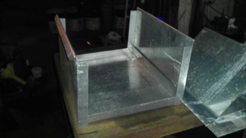 1989 Ford Bronco - Metal ductwork assembly on a workbench in a workshop setting.