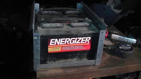 1989 Ford Bronco - Energizer car battery in a metal bracket, with warranty information visible on the label.
