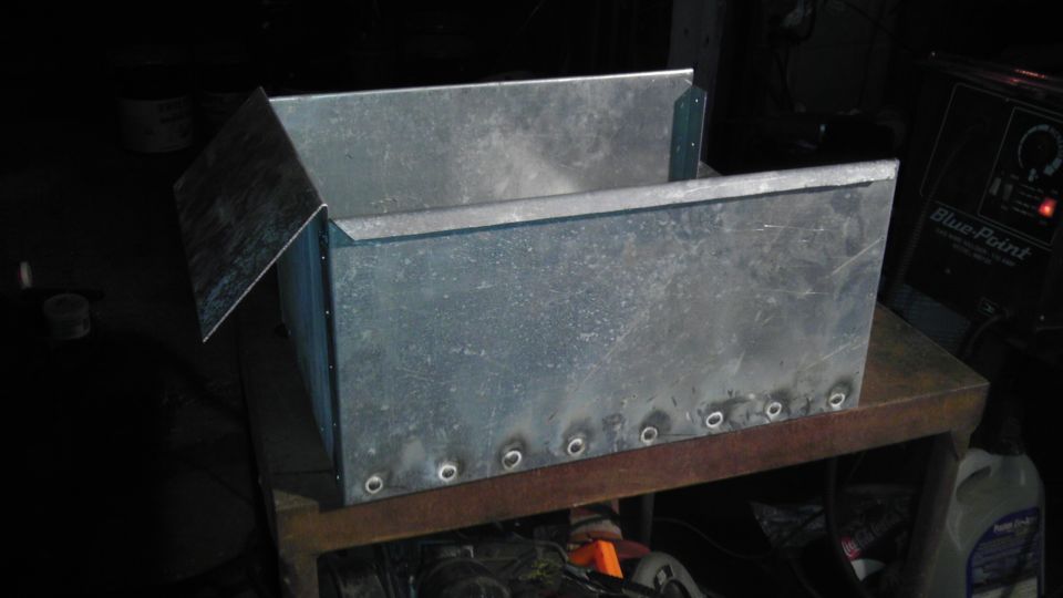 metal box with rivets on a workbench