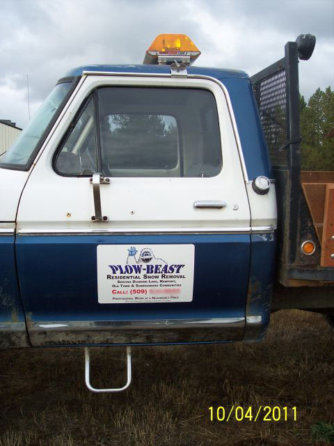 1973 Ford F-250 - Close side view of the cab door on a blue-over-white Ford pickup, showing a white magnetic sign reading "PLOW-BEAST Residential Snow Remova…