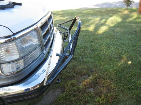 1994 Ford Bronco - Close-up of a Ford truck's front end, showing a custom bumper and a tape measure for scale.