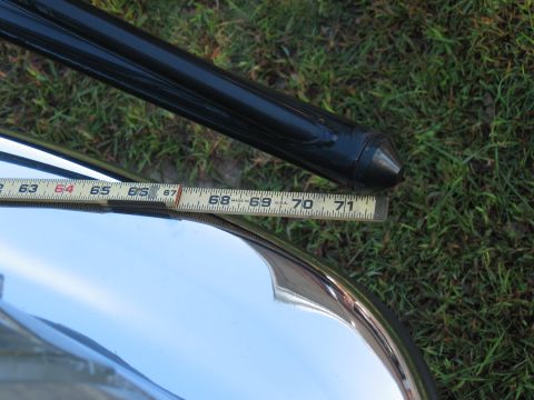 1994 Ford Bronco - A chrome bumper and a black bar are measured with a tape measure.
