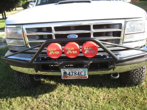 1994 Ford Bronco - Front view of a white Ford truck with a brush guard and Baja Laser lights, showing a Virginia license plate.