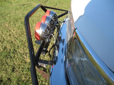 1994 Ford Bronco - A Pro Runner light bar with three chrome and red lights is mounted on the front of a vehicle.