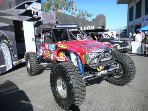 1997 Ford Ranger - Custom off-road buggy with extensive modifications and sponsor decals is displayed outdoors.
