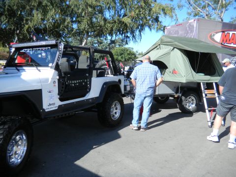 1997 Ford Ranger - A modified Jeep Wrangler is shown next to a trailer equipped with a rooftop tent.