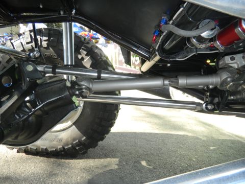 1997 Ford Ranger - Close-up view of the complex undercarriage of a heavily modified vehicle, showing its robust suspension and steering systems.