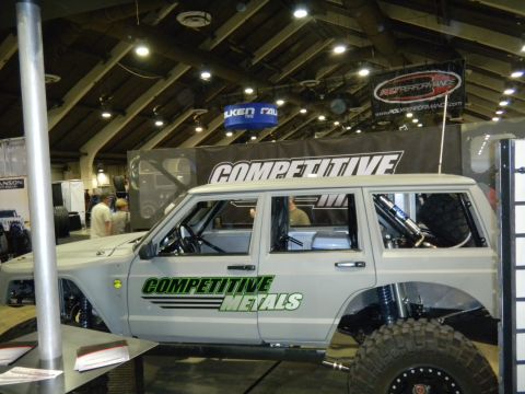 1997 Ford Ranger - A custom-built SUV with off-road modifications is displayed indoors, possibly at a show.