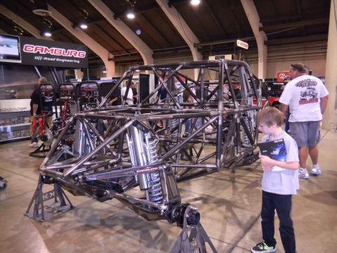 1997 Ford Ranger - A custom off-road racing chassis is displayed at an event, with spectators nearby.