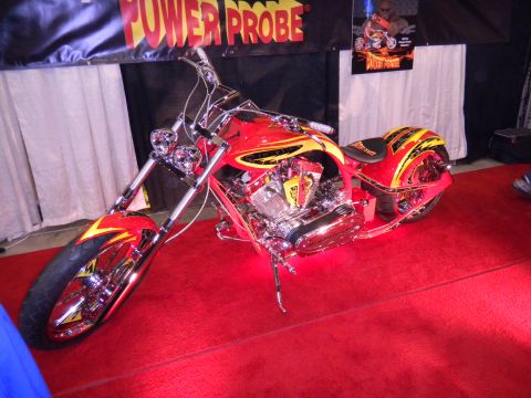 1997 Ford Ranger - A custom chopper motorcycle with flame graphics is displayed on a red carpet.