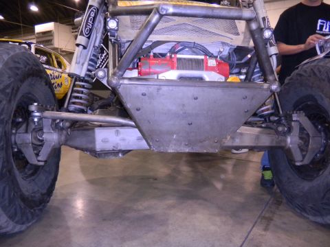 1997 Ford Ranger - Close-up view of the front suspension and winch system on a custom-built off-road vehicle.