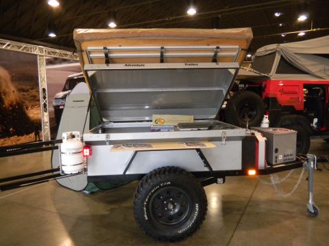 1997 Ford Ranger - An off-road trailer with a rooftop tent is displayed next to a red Jeep.