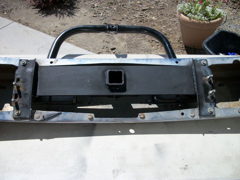 1992 Ford Bronco front bumper assembly with black bull bar and hitch receiver, chrome trim, off-white paint