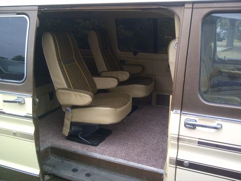 1979 Ford E250 - Interior view of a 1979 Ford E250 van, captain's chairs and carpeted flooring.