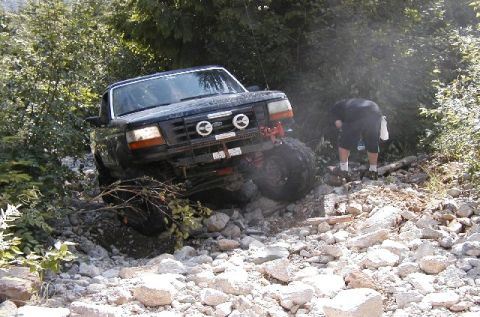 1993 Ford Bronco - This 1993 Ford Bronco is shown off-roading over a challenging, rocky path.