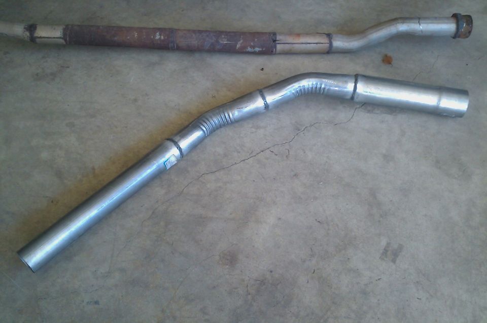 old rusty exhaust pipe next to a new bent exhaust pipe
