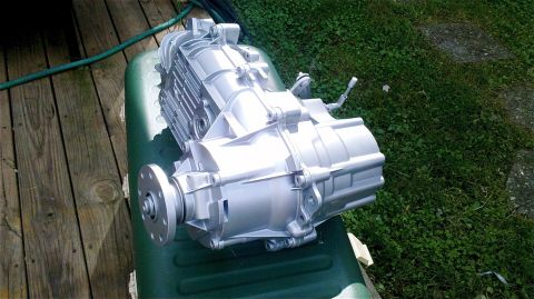 1995 Ford F-150 - ZF5 transmission shown outdoors on a green container next to grass and wooden planks.