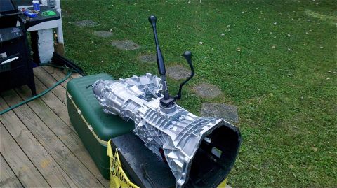 1995 Ford F-150 - A manual transmission is shown resting on a cooler outside on a wooden deck.