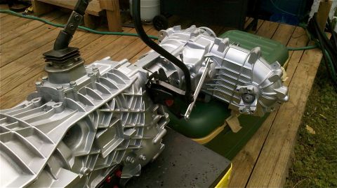 1995 Ford F-150 - A silver transmission assembly with a black shifter is shown on a wooden surface.