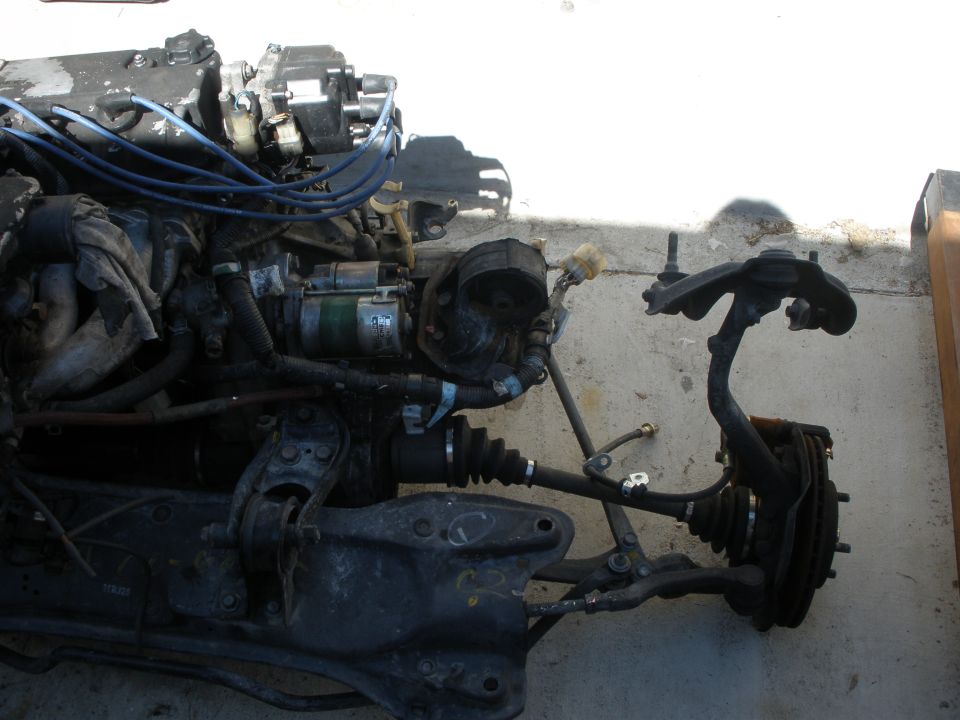 Engine assembly and front suspension parts, likely from a Honda CRX
