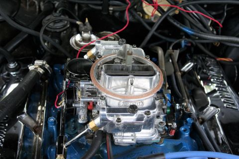 1976 Ford Ranchero - Close-up of a carburetor and engine bay components, with visible text from Supermotors.net.
