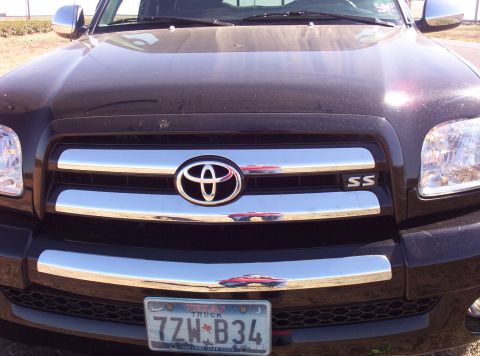 1988 Ford Bronco - The Toyota emblem is centered on a chrome grille with 'SS' badging on the right side.