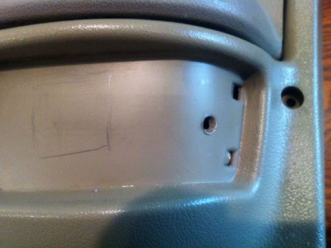 2001 Mercury Grand Marquis - Close-up of an interior door panel showing pencil marks and mounting holes.