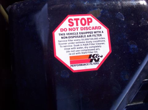 1988 Ford Bronco - A K&N Performance Filters sticker is affixed to a dark surface, providing instructions for air filter maintenance.