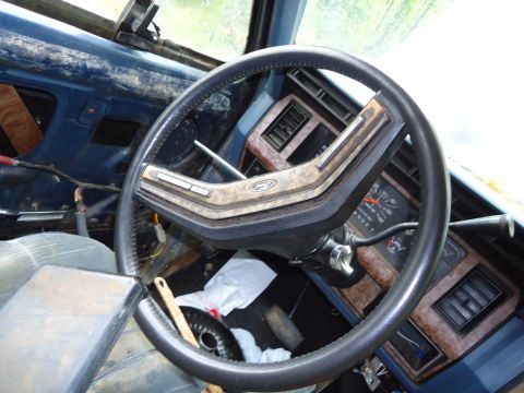 1985 Ford Bronco - Interior view of a 1985 Ford Bronco, its dashboard and steering wheel.