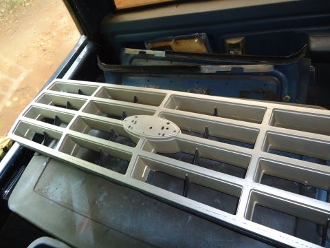 1985 Ford Bronco - A silver Ford grille with an oval emblem is shown, likely for a truck or SUV from the early 1980s.