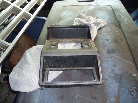 1985 Ford Bronco - Center console trim piece with openings for radio and storage, possibly from an older vehicle.