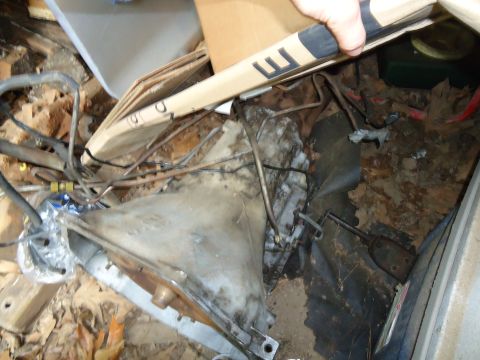 1985 Ford Bronco - A vehicle part, likely from a transmission, is shown in a cluttered environment with debris.
