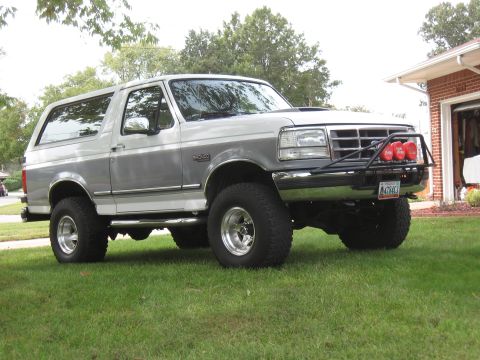 1994 Ford Bronco - This two-tone 1994 Ford Bronco features an aftermarket bull bar with auxiliary lights and large off-road tires.