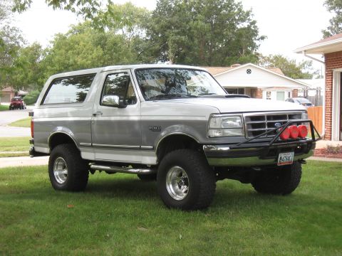 1994 Ford Bronco - Silver and grey 1994 Ford Bronco with lifted suspension and off-road lights.