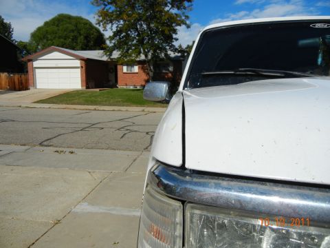 1996 Ford Bronco - White Ford truck parked in a suburban driveway on a sunny day.