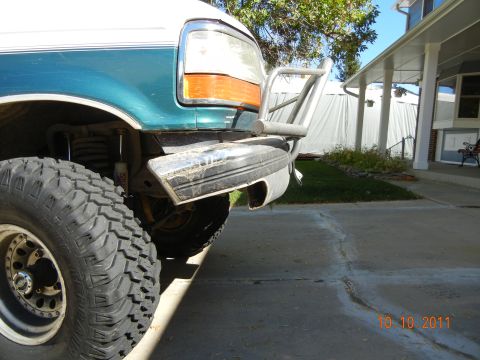 1996 Ford Bronco - This 1996 Ford Bronco features a custom bumper and off-road tires, seen from a 3/4 front angle.