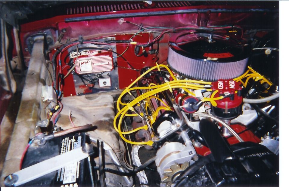V8 engine bay with yellow MSD plug wires, MSD ignition box and round air filter