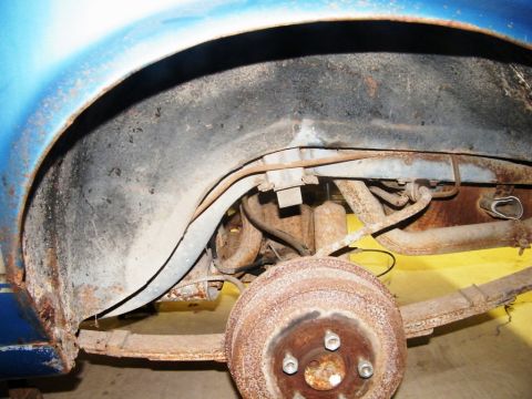 1970 Ford Mustang - The underside of a vehicle shows significant rust on the suspension and brake components.