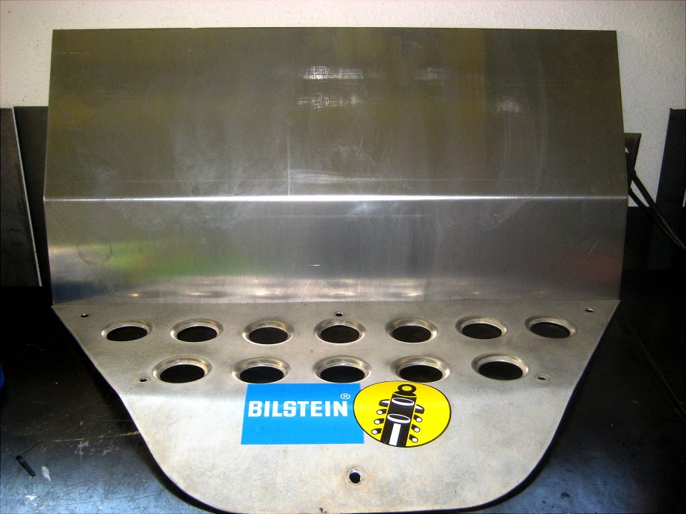 Aluminum plate with Bilstein logo and a graphic of a shock absorber