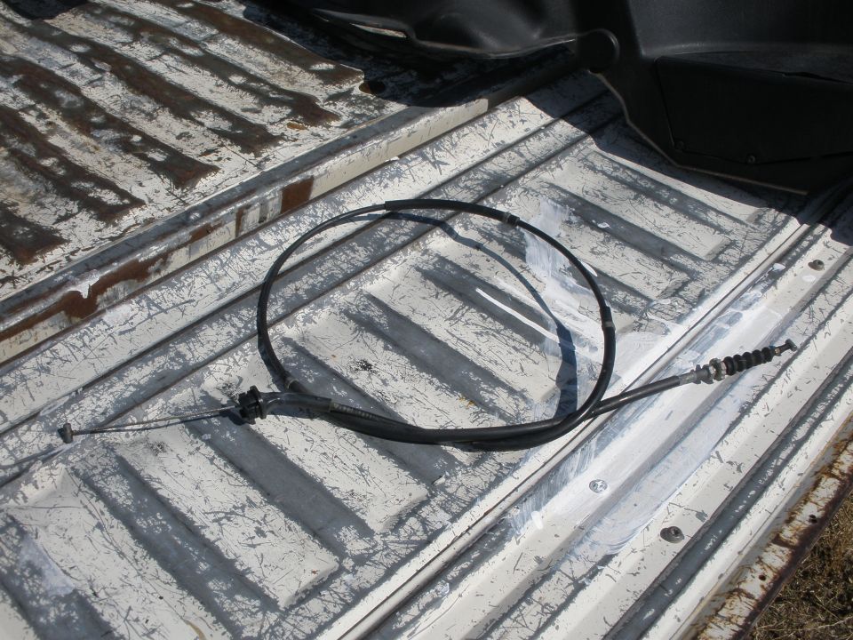Throttle cable lying on a worn truck bed