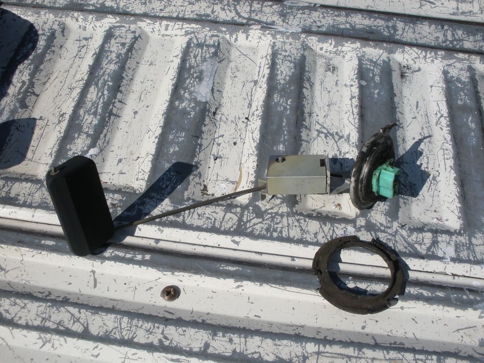 Fuel sending unit with float and seal on a white truck bed