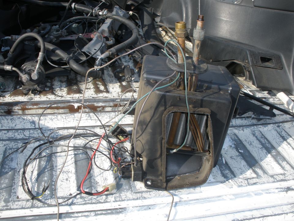 Heater core and blower assembly with wiring and hoses removed from a vehicle