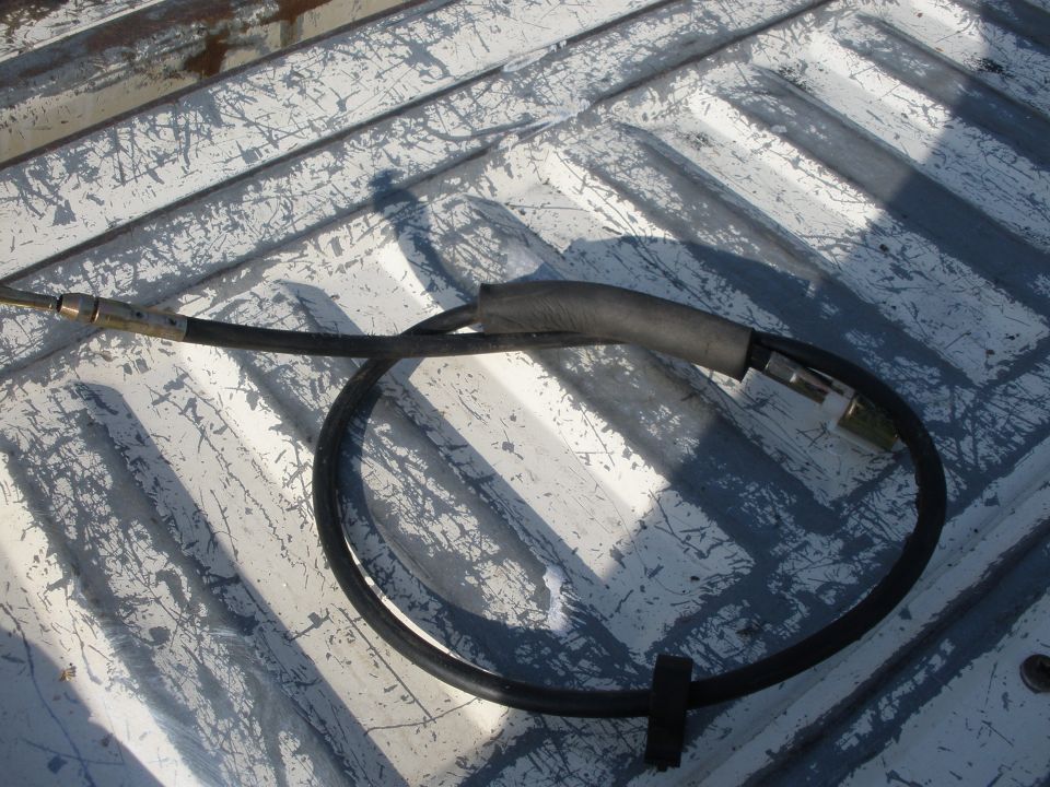 Brake cable resting on a white truck bed