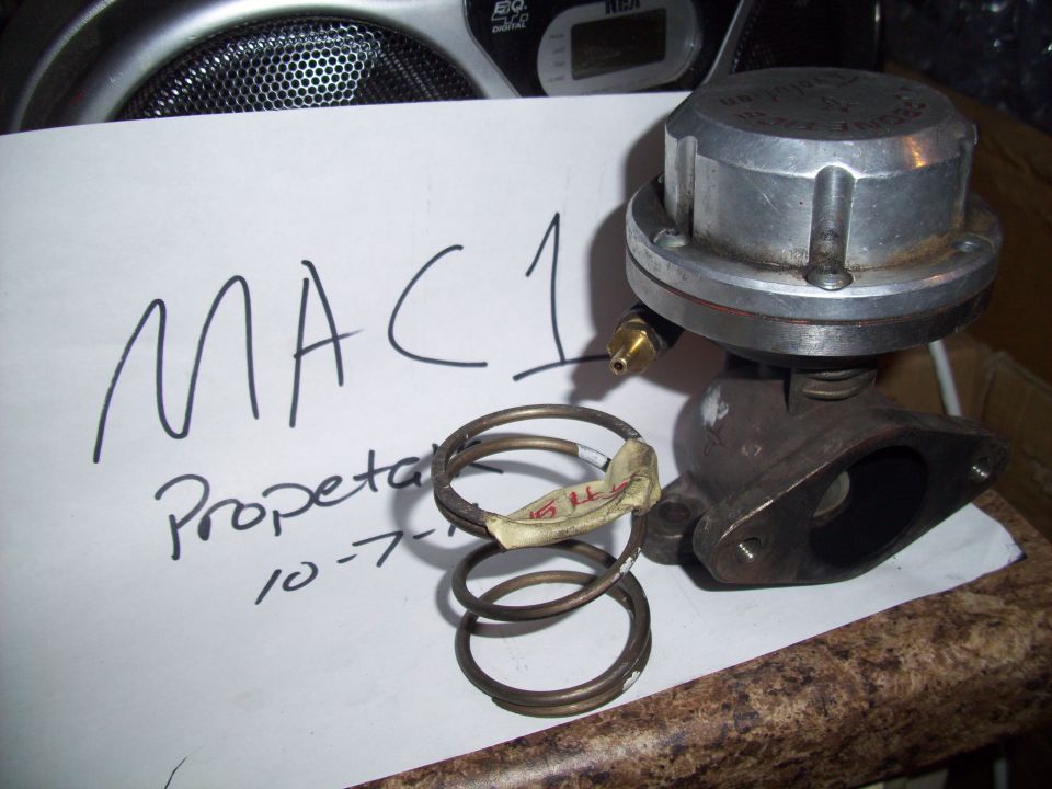 Turbo wastegate actuator with springs and handwritten "MAC 1 Propeta 10-7-" on paper