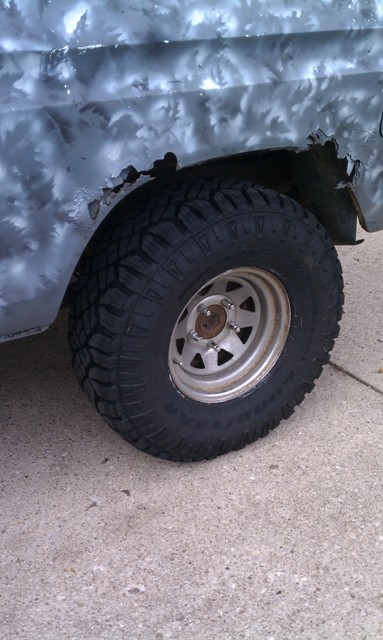 1978 Ford Bronco - This image shows the rear wheel and fender of a vehicle, custom paint and visible rust around the wheel well.